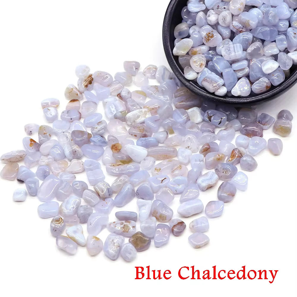 A pile of light blue to lavender blue chalcedony crystal stone chips in a black bowl.