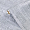 Roll of gray wood grain vinyl wallpaper contact paper showing a peel and stick edge.
