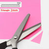 Stainless steel pinking shears with a triangle edge shown on pink paper
