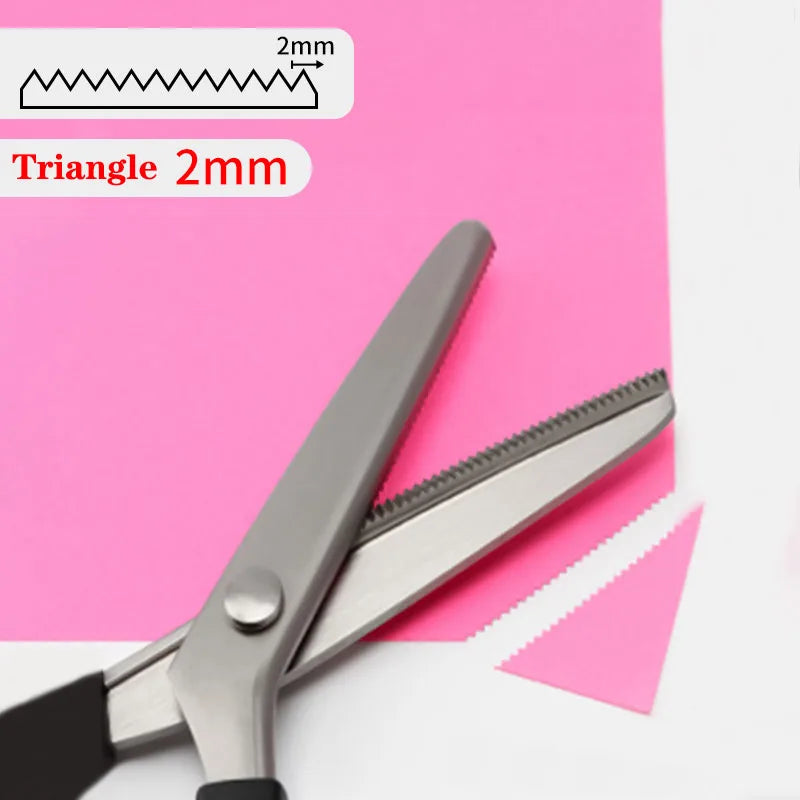 Stainless steel pinking shears with a triangle edge shown on pink paper