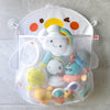 A white mesh bag with a duck face design holds various bath toys and accessories.