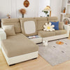 A beige jacquard elastic sofa slipcover with light gray fabric and white accents sits on a wooden floor.