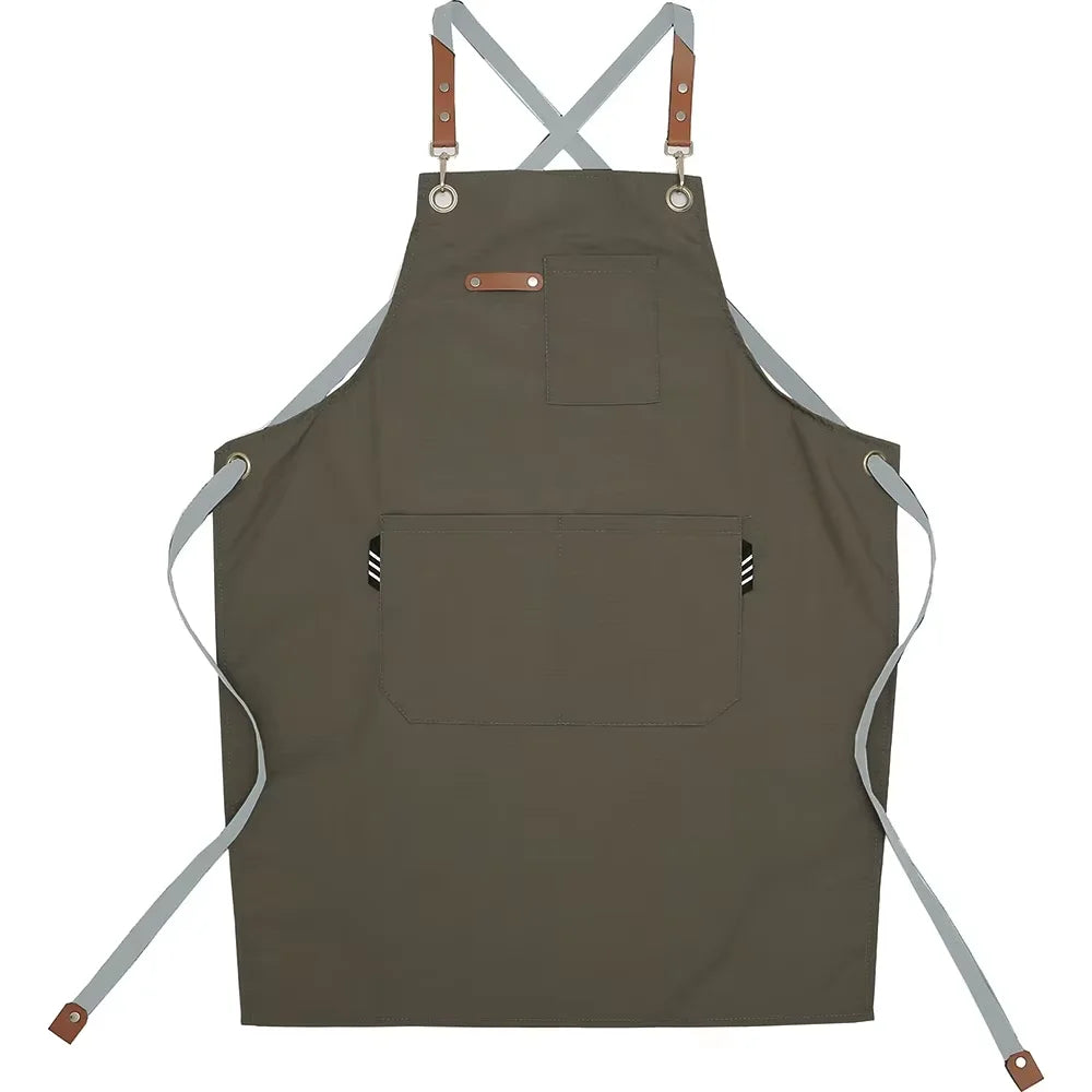 A dark olive green adjustable cotton canvas apron with multiple pockets and leather ties.