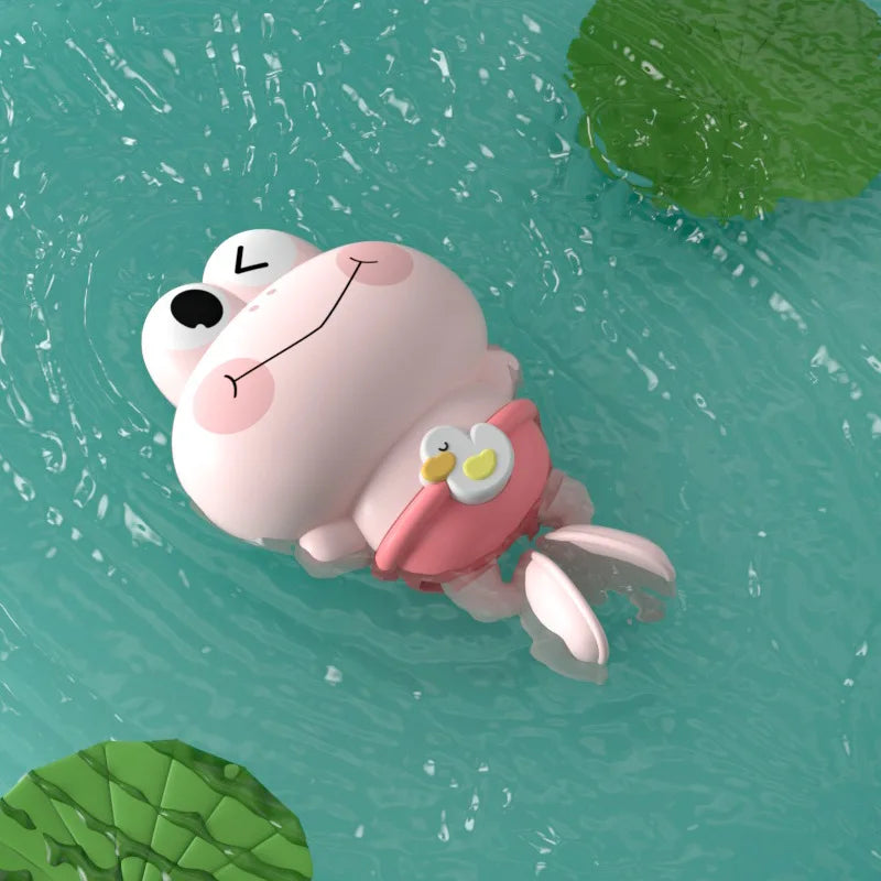 A pink cartoon turtle toy floating in blue water with green foliage visible.