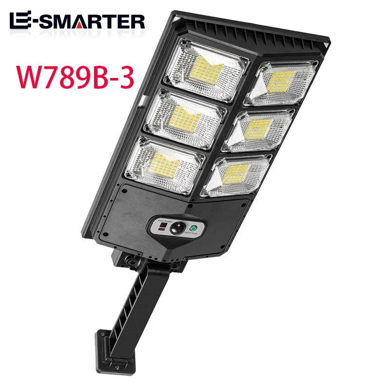 A black motion-activated solar garden light with four LED floodlights mounted on a stand.
