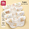 A set of five white soft cotton muslin bandana bibs for babies with cute animal designs
