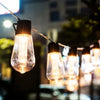 String lights featuring vintage Edison bulbs hanging outdoors at night
