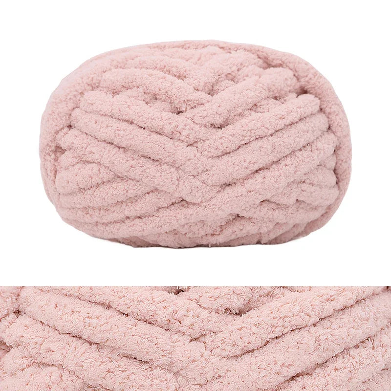 A ball of pink chunky chenille yarn used for hand knitting and crochet