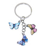 A silver hoop keychain charm featuring colorful butterfly charms.