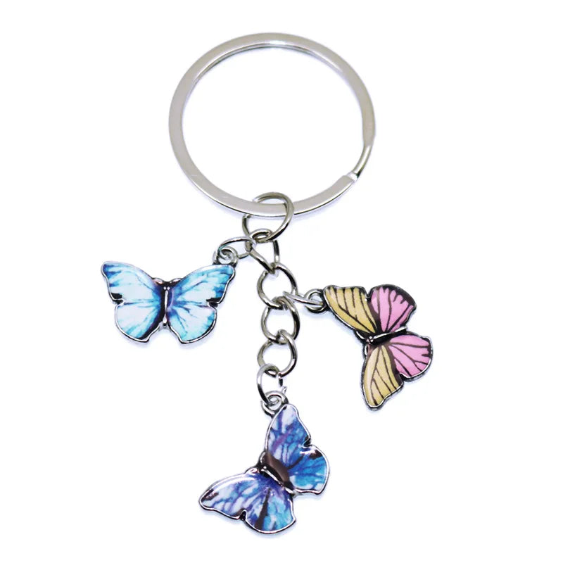A silver hoop keychain charm featuring colorful butterfly charms.