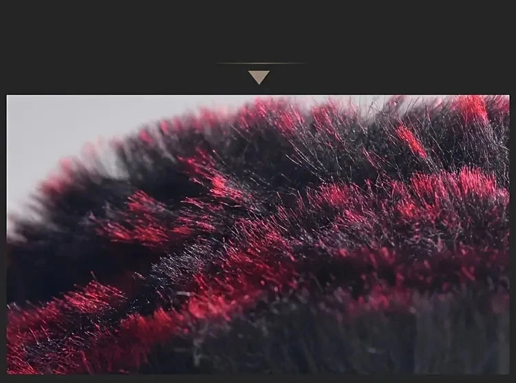 Close-up of a dark plush steering wheel cover with vibrant red and black fibers.