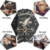 A black waterproof hair cutting cape featuring various barber tools and styling imagery.