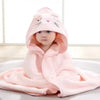 A baby wearing a pink hooded bathrobe towel with a cartoon cat design.