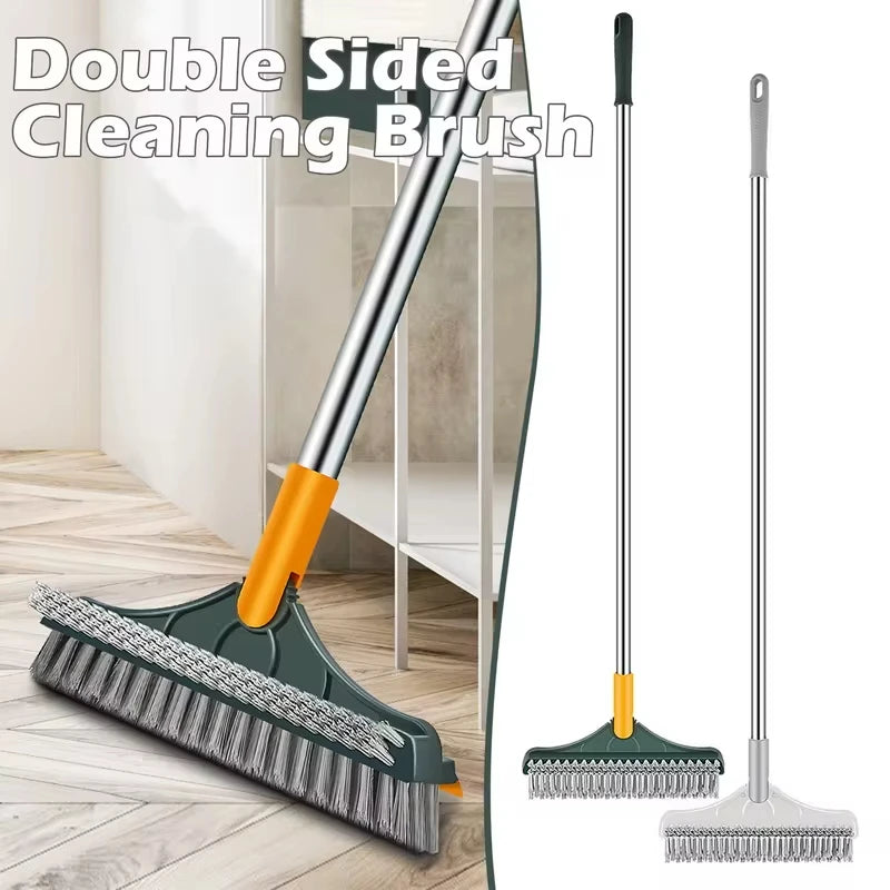A double-sided cleaning brush with a long handle and a flat scrubbing head shown on a wooden floor.
