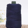 A dark navy blue crochet ice rope with a green cap, coiled on a woven mat.