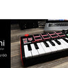 Black AKAI Professional MPK Mini keyboard controller with drum pads and knobs on a wooden surface.