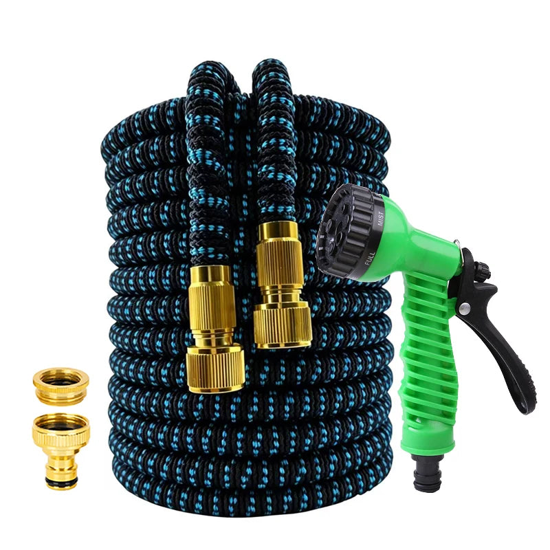 A coiled black garden hose with gold fittings and a green high-pressure nozzle attached.