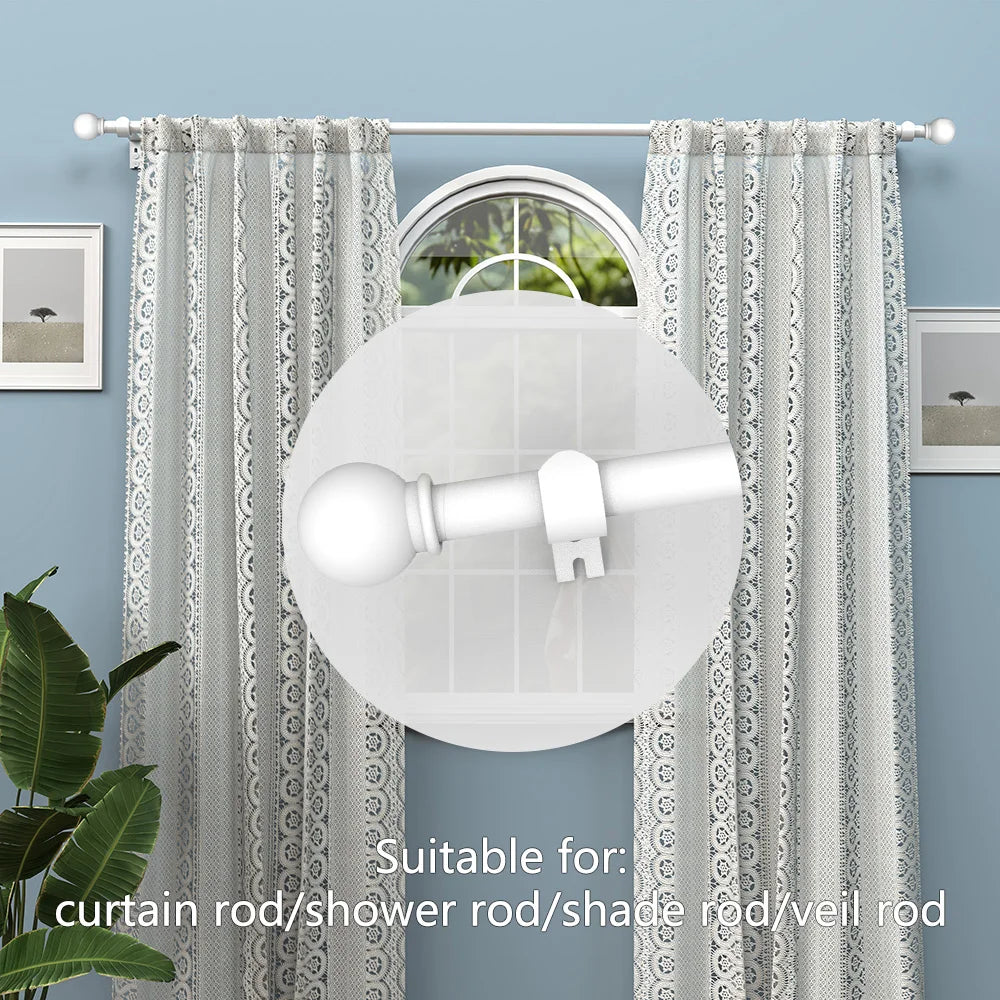 A white classic iron curtain rod with decorative ball finials shown against a light blue wall and sheer fabric.