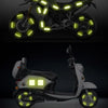 A motorcycle and a scooter both feature bright yellow LED light strips around the wheel hubs.