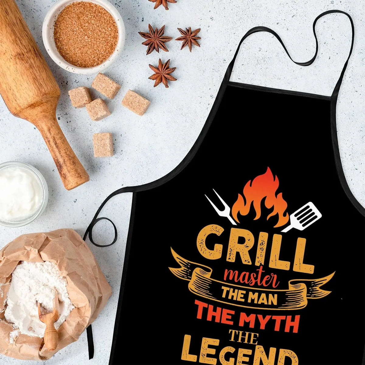 Black apron with yellow text featuring the phrase Grill master the man the myth the legend