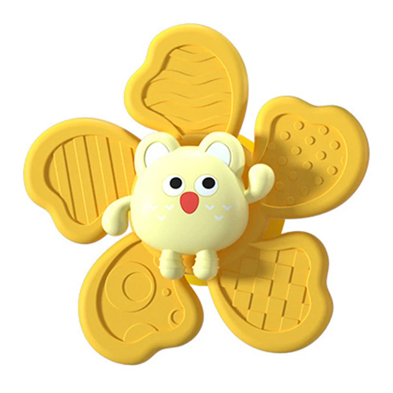 A yellow suction cup spinner bath toy shaped like a cute, round animal for toddlers.