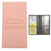A pink leather card holder wallet for vehicle registration and insurance cards, shown next to an open black sleeve.