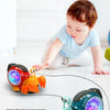 An interactive crawling crab toy with music and lights is shown on a white floor.