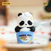 A cute panda blind box figure sitting in a blue cup with food inside.