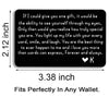 A black metal wallet card with a heartfelt love message engraved on it.