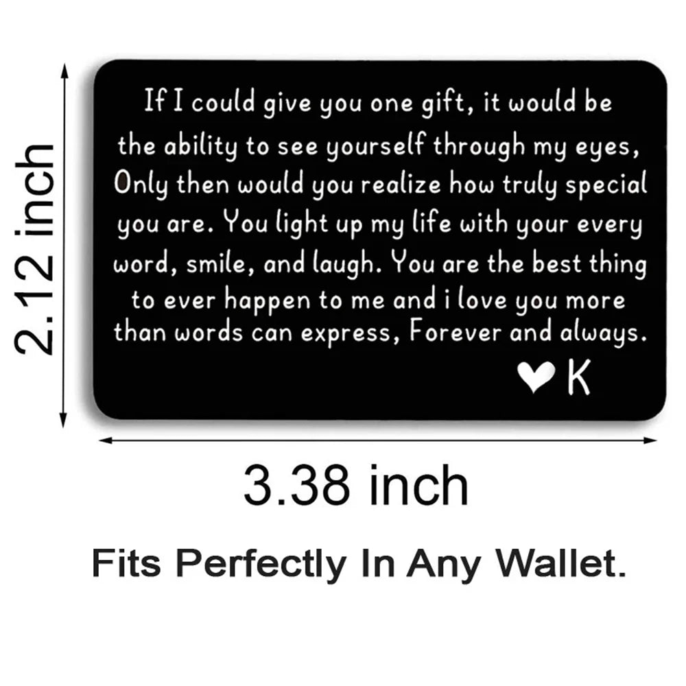 A black metal wallet card with a heartfelt love message engraved on it.