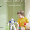 A young child is interacting with a white robot toy on the floor in a bright room.