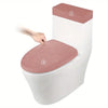A white toilet seat with a pink fleece cover and lid, showing two numbered points on the seat.