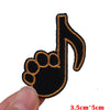Black and gold embroidered iron-on patch shaped like a hand with a musical note.