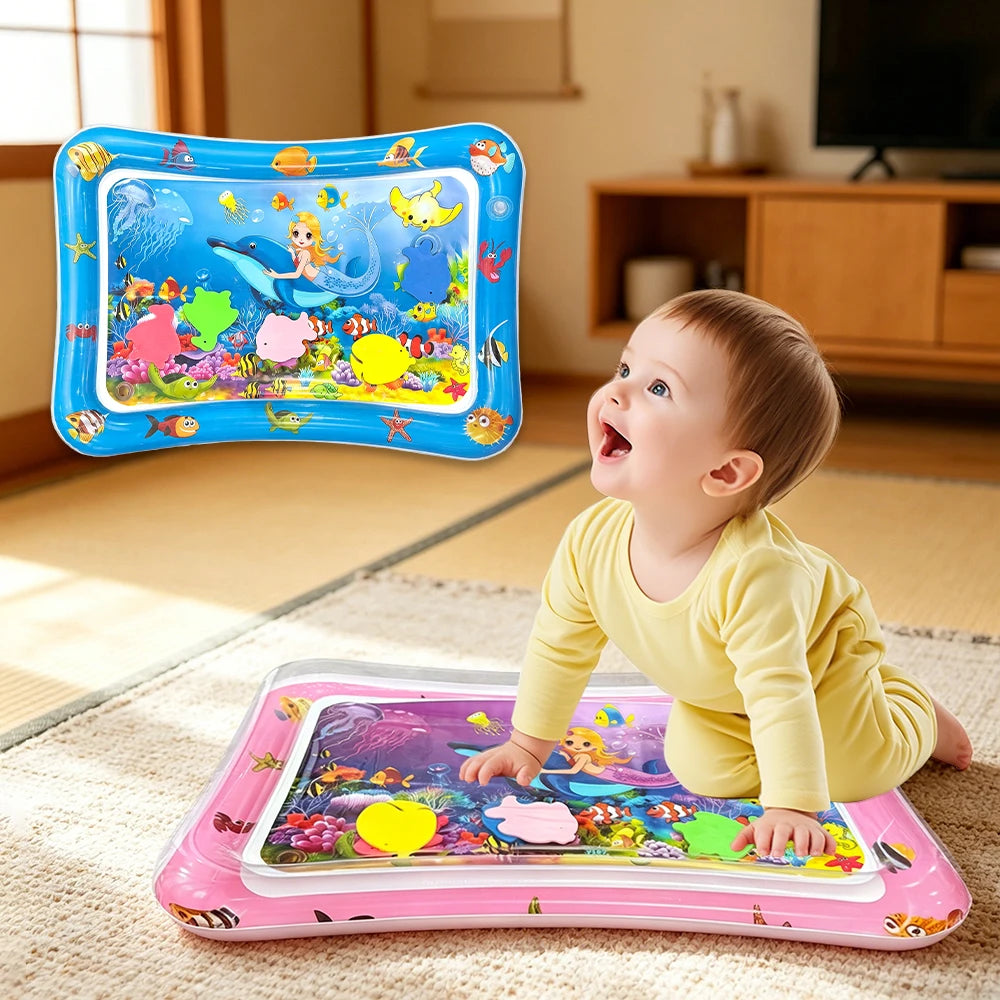 A baby is playing with a colorful inflatable ocean-themed water play mat designed for sensory development.