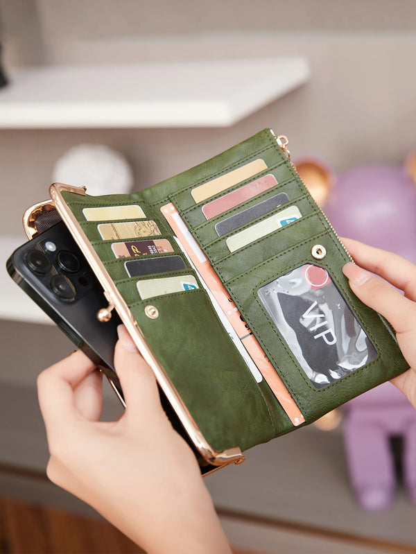 A hand holds a green leather wallet with multiple cards and a phone, resting on a light shelf.