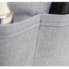 Close-up of a gray purse organizer insert with a divider and a metallic item visible inside.