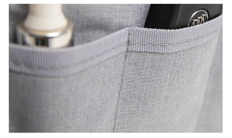Close-up of a gray purse organizer insert with a divider and a metallic item visible inside.