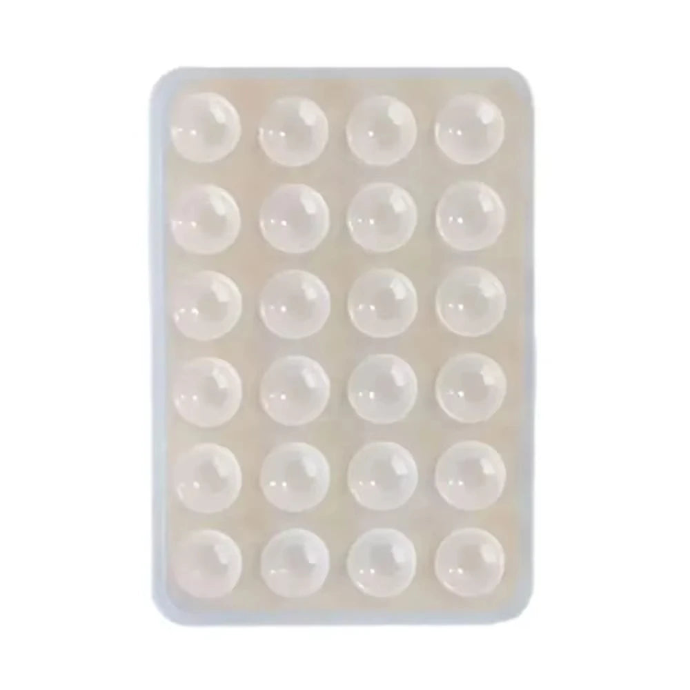 A clear plastic tray containing multiple reusable silicone suction cup phone mounts.