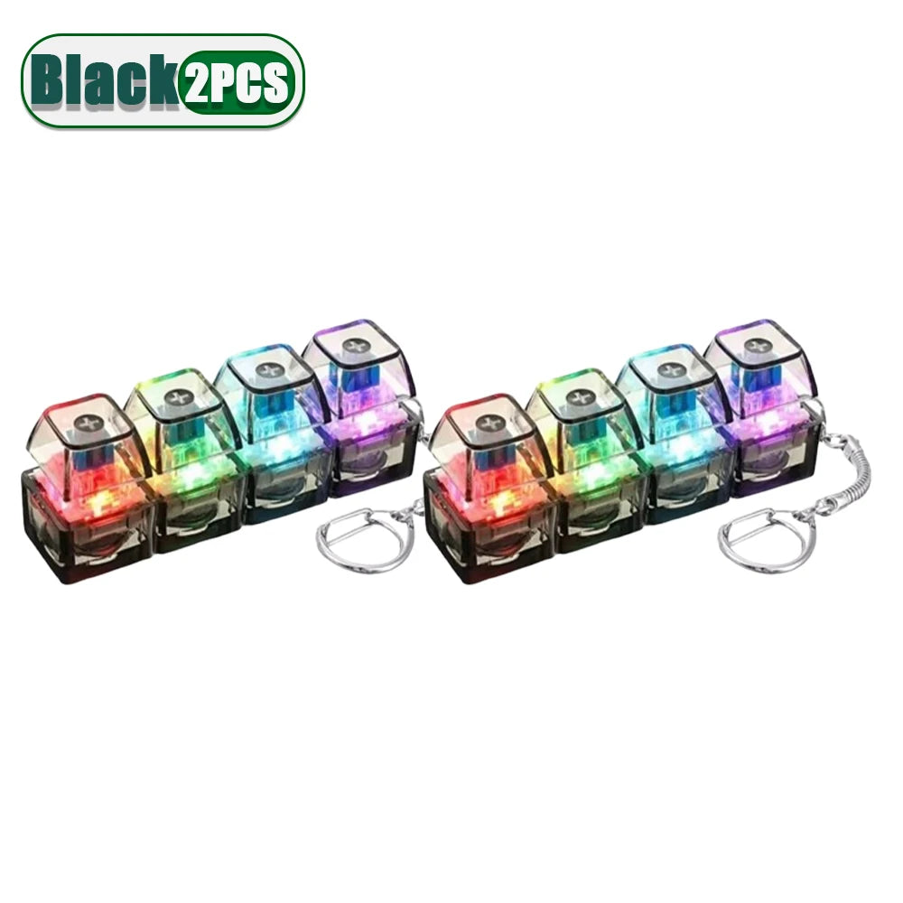 A set of black 2-piece LED clickable fidget keychains with a keyboard design.