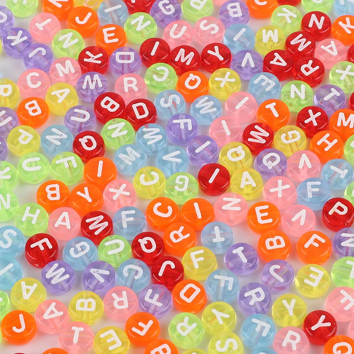 A collection of colorful acrylic alphabet letter beads in various shades of red, orange, green, and purple.