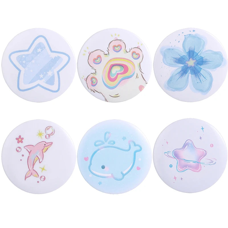 A set of five tinplate pins featuring designs of a star, a cat face, a dog paw, a heart, and a fish.