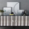 A display of black and white striped self-adhesive wallpaper rolls against a gray wall with abstract artwork.