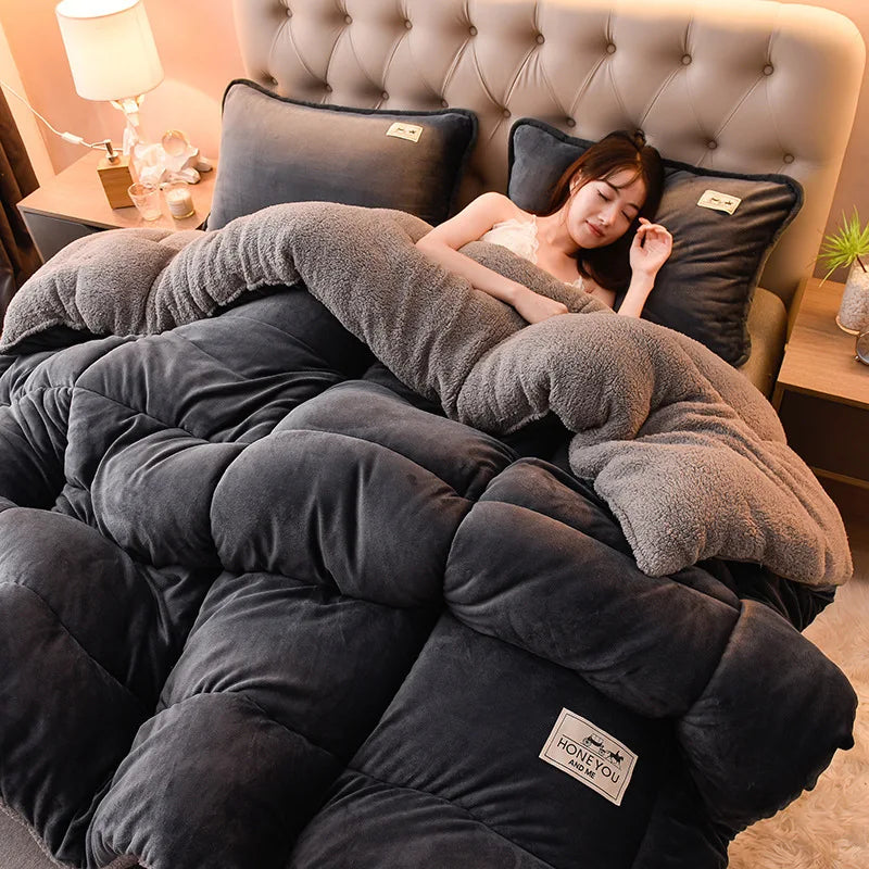 A person relaxing under a cozy double-sided velvet warm quilt blanket on a bed.