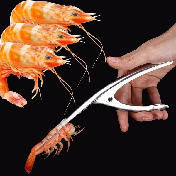 A hand holds a stainless steel shrimp peeler and deveiner, demonstrating its use on a cooked shrimp.
