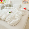 A white lightweight seersucker duvet cover set displayed on a bed with decorative pillows and a stuffed animal.