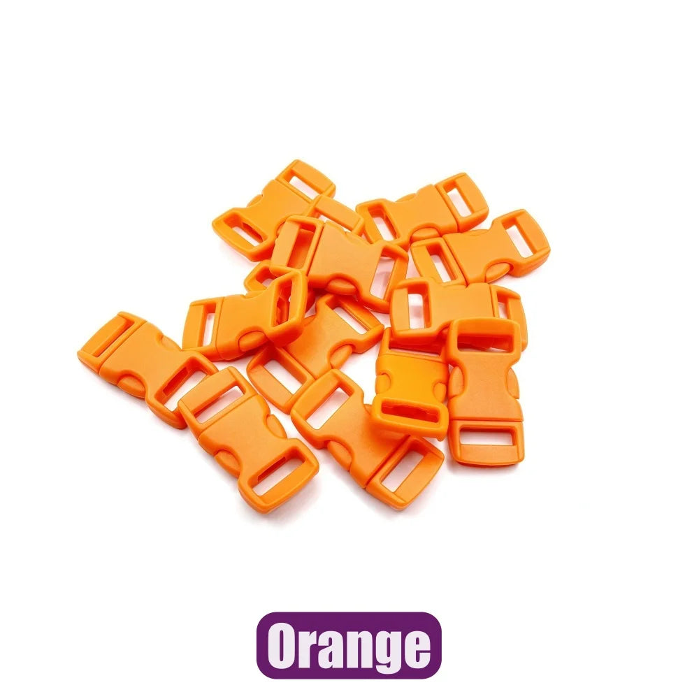 A pile of bright orange plastic side-release buckles for paracord bracelet projects.