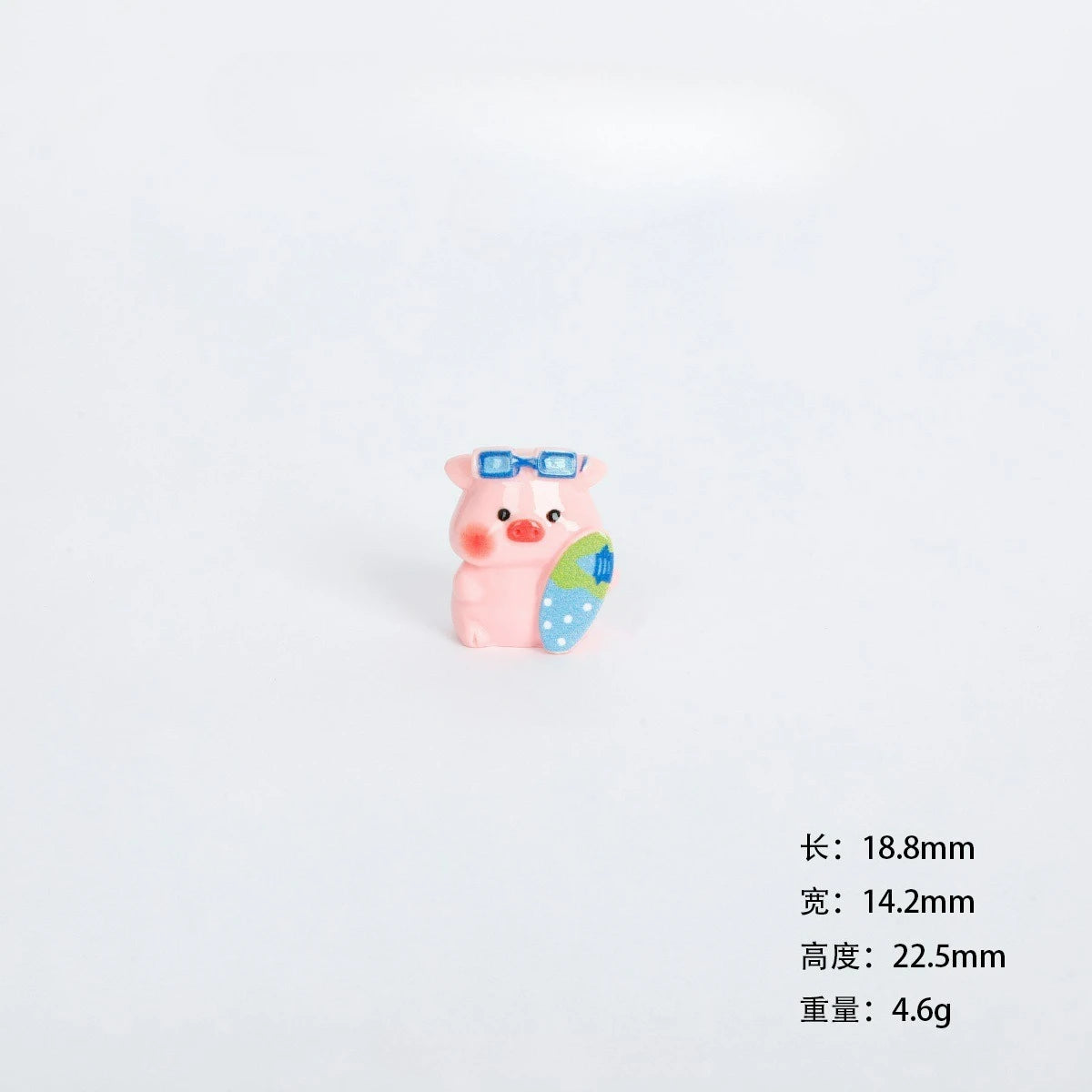 A small pink resin figurine of a pig with blue eyes and a green accessory.