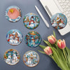 A collection of eight diamond art coasters featuring winter and seasonal designs on wooden bases.