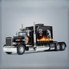 A black 1:24 scale diecast Peterbilt 389 heavy truck model with pull-back action, sound, and lights.