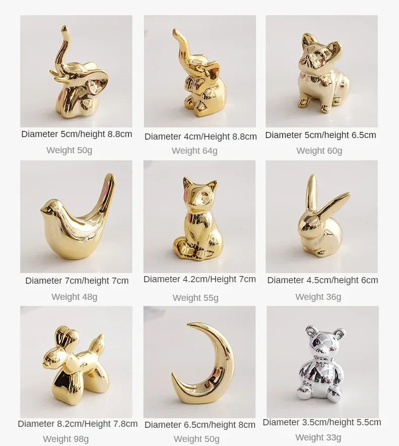 A collection of handcrafted ceramic elephant and rabbit jewelry holders and desk ornaments in gold color.